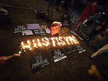 Candle-lighting protest condemning the New Bataan massacre, March 6. The candles spell out Hustisya!, Filipino for "Justice!" Candle-lighting protest vs New Bataan 5 massacre.jpg