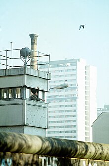 Berlin Wall top and guard tower DF-ST-91-01465.JPEG