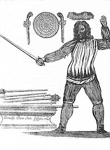 Portrait of Donald McBane, a Scottish fencing master, from Donald McBane's The Expert Swordsman's Companion (1728). This image portrays McBane in the "Inside Guard" with a broadsword, while the table next to him has both broadswords and smallswords. The wall behind him has a targe with flintlock pistols on each side Donald McBane, Scottish Fencing Master.jpg