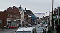 English: Dorking High Street, Dorking, Surrey, in July 2009. The photograph is taken looking roughly north east, with the A25 road heading towards Reigate. The photo was taken near the White Horse pub, between the junction of the road with Mill Lane and Lyons Court.