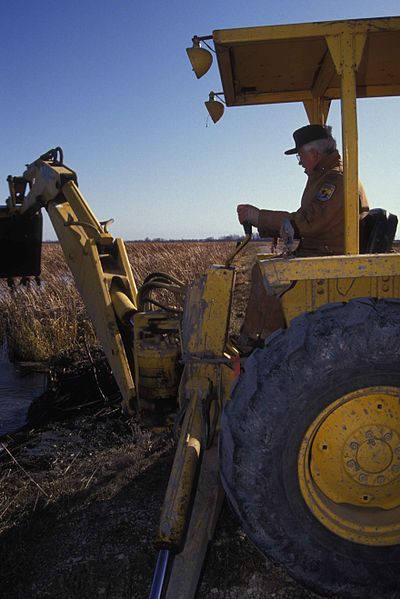 File:Employee uses tractor to manage a wetland habitat area.jpg