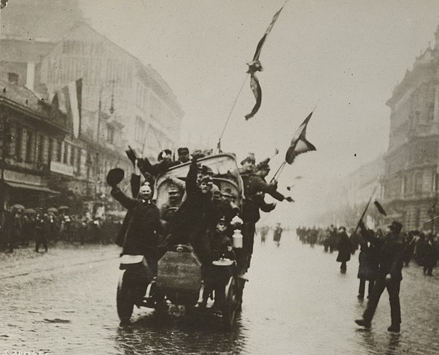 An automobile loaded with communists dashing through streets of Budapest, March 1919