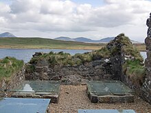 Ruins on Eilean Mor in Loch Finlaggan, looking toward the Paps of Jura and the hills of Islay Finlaggan.jpg