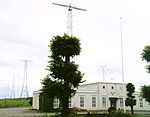 White main building and antennas in the background