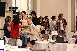 Newcomers and mentors discussing projects during the mentoring program at Wikimania Hackathon