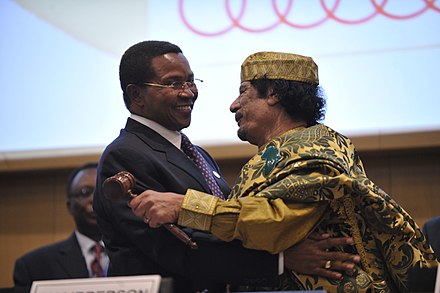 Muammar Gaddafi embracing Tanzanian President Kikwete after assuming the chairmanship