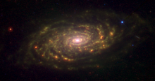 Messier 63 seen in the infrared by the Spitzer Space Telescope. The infrared radiation traces the dust within the spiral arms, which does not radiate visible light. A small dust ring can be seen just outside of the galaxy's center.[18]