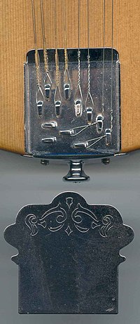 Mandolin tailpiece, which simply anchors the strings solidly Mandolin tailpiece.jpg