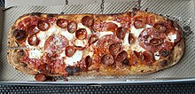 Typical oblong pizza from &pizza in Washington, D.C., in April 2024 Modified maverick pizza without Italian sausage.jpg