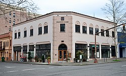 Photograph of a two-story commercial building on a city street corner