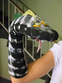 A sock puppet decorated to look like a snake SIMI Night.jpg