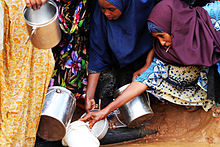 Women distributing water at the base. Somwatjug.jpg