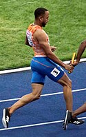 A sprinter passing the baton to his team mate, 2018