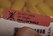 Auxiliary label stating the medication must be swallowed whole, without crushing or chewing. Swallow whole auxiliary label.jpg