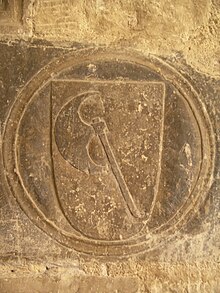 Emblem of the Order of the Hatchet in the stone of the cloister of the Cathedral of Tortosa, (c. 14th century) TortosaOrdeAtxa.JPG