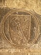 Écu de l’ordre de la Hache, sculpté dans la pierre du cloître de la cathédrale de Tortose (XIVe siècle).