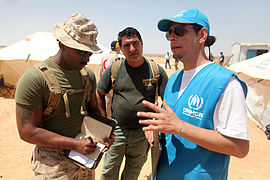 An UNHCR-officer talks with a Marine during Exercise Eager Lion 12