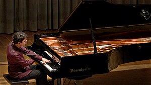 Pianist Vadim Chaimovich performing on a Bösendorfer grand piano on the stage of the Onoldia Concert Hall in Ansbach, Germany, on October 22, 2015