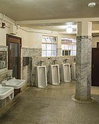 An example of floor standing urinals in a men's bathroom.