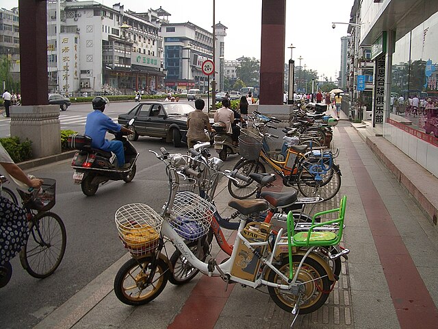 Electric bicycles parked in Yangzhou's main street, Wenchang Lu. They are a very common way of transport in this city, in some areas almost outnumberi