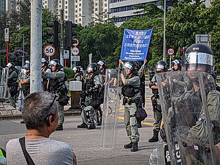 Riot police showing the "blue flag", warning protesters to disperse