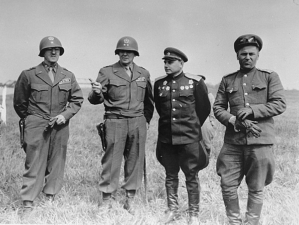 American and Soviet generals pose on the banks of the Elbe River near Torgau, Germany, where the two Allies linked up for the first time in 1945. Pict