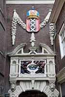 The relief of Joost Jansz Bilhamer above the orphanage gate in Kalverstraat grouped with orphans at the Orphanage of the emblem: a white dove, the symbol of the Holy Spirit..Amsterdam, The Netherlands