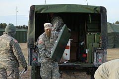 U.S. Army Reserve soldiers unpacking a Humvee-based assault kitchen