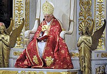 A red papal cope, worn with a mitre by Pope Benedict XVI Benoit xvi manteau.jpg