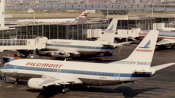 The initial 737-300 (foreground) is 9 ft 5 in (2.87 m) longer than the 737-200 (background) and is re-engined with wider and more efficient CFM56 turb