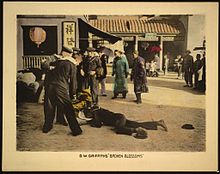 Lobby card for the film, showing the early scene in which drunken Western sailors fight on a street in China Broken blossoms lobby card LOC.jpg