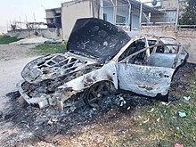 A car set on fire by Israeli settlers during the Huwara rampage Burnt Car in Huwara.jpg