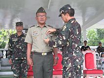 Newly promoted CPT ROMEO C MENDOZA (RES) PA is awarded by BGEN MARCELO B JAVIER JR (RES) AFP; commanding general.15th Infantry Division, ARESCOM with the Military Merit Medal for his contributions to TF Maring.