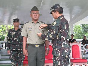 Newly promoted CPT ROMEO C MENDOZA (RES) PA is awarded by BGEN MARCELO B JAVIER JR (RES) AFP; Commanding General. 15ID(RR),ARESCOM with the Military Merit Medal for his contributions to TF Maring.