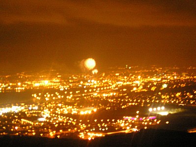 The view of Belfast by night, from Carnmoney Hill (fireworks from the New Years celebrations can clearly be seen in the skies above Belfast's SSE Arena)