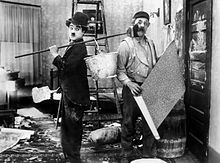 A slapstick scene from the 1915 Charlie Chaplin film His New Job. Chaplin started his film career as a physical comedian, and his later work continued to contain elements of slapstick. Chaplin, Charlie (His New Job) 03.jpg