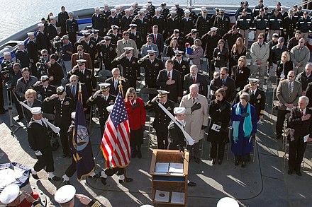 Crew members and guests salute as the colors are paraded at the decommissioning ceremony of the salvage and rescue ship Grasp
