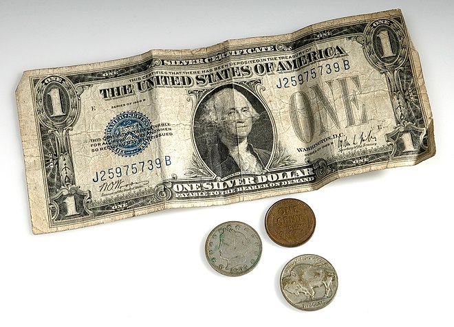 A United States dollar bill, two five-cent coins and a penny