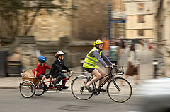 Adult and two children cycling using two-wheeled tandem trailer bike (a Pashley U+2)