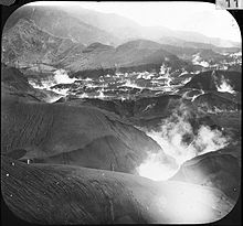 View of river with craters in background. Craters are the result of interaction of the river water or ground water with hot ash. The hot ash is the deposit of nuée ardentes. 30 May 1902.