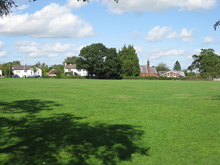 The Common at Holmer Green showing the village hall and parish church