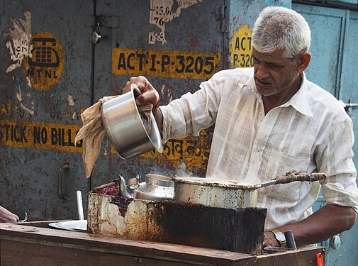 Cooking pots for coffee in an open street café in Mumbai, India