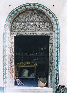 Swahili Arabic script on a sarved wooden door (open) at Lamu in Kenya Lamu door.jpg