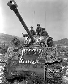 US soldiers prepare to advance along the Han River area, Korea, in their M4A3E8 Sherman tank (painted with a tiger scheme as a psychological effort to undermine Chinese morale), during offensive launched by the 5th RCT against the Chinese forces in that area. M1tankKoreaHanriver1951.jpg