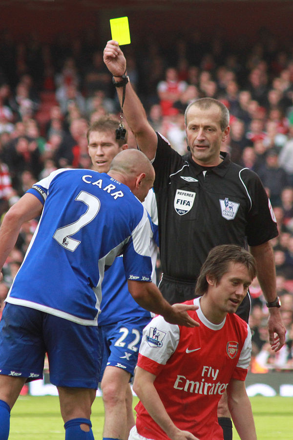 Atkinson issues a yellow card during a fixture between Birmingham City and Arsenal in 2010