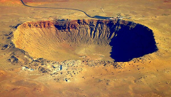 The 1,200 meter-wide Meteor Crater in Arizona, United States, created by a 46 meter-diameter asteroid impact. A visitors centre is visible beyond the 