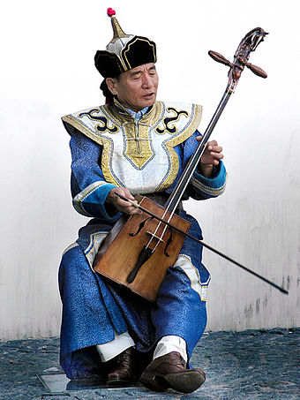 Musician playing the traditional Mongolian musical instrument morin khuur