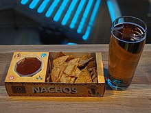 Some movie theaters in Finland sell alcohol to take along to the movie itself in select showings. Such showings are always adults-only, regardless of the rating of the movie. Nachos and beer at a Finnkino movie theatre in Itakeskus.jpg