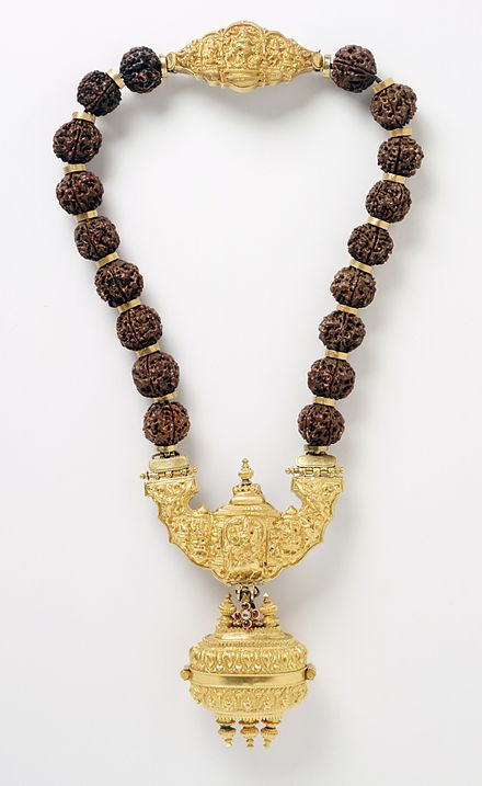 A necklace with pendant containing linga symbol of Shiva are worn by Lingayats. Rudraksha beads (shown above) and Vibhuti (sacred ash on forehead) are other symbols adopted as a constant reminder of one's principles of faith.[73]