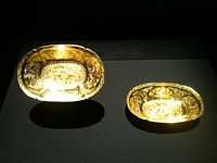 Two Tang oval lobed gold bowls each with two ducks in repoussé among chased flowers
